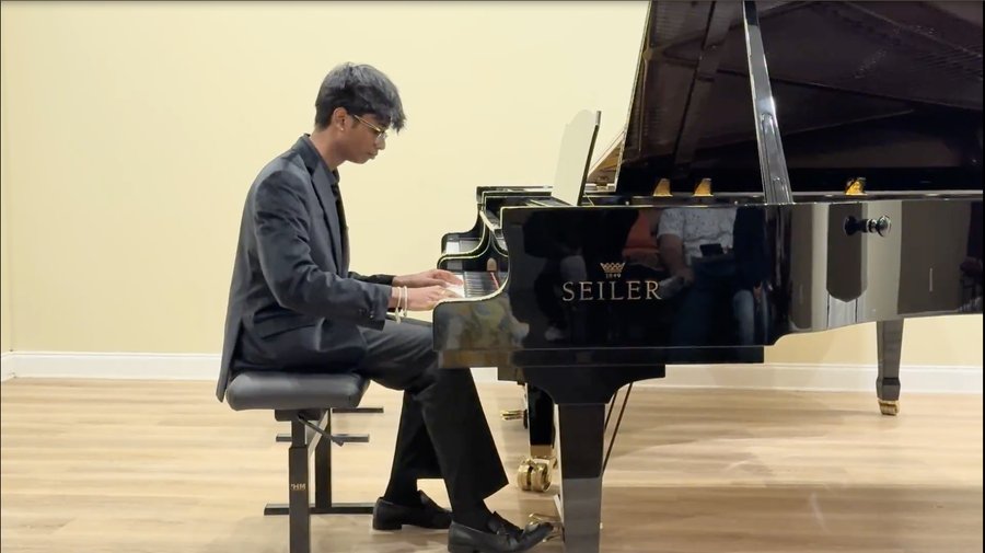 Sai performing at a piano recital
